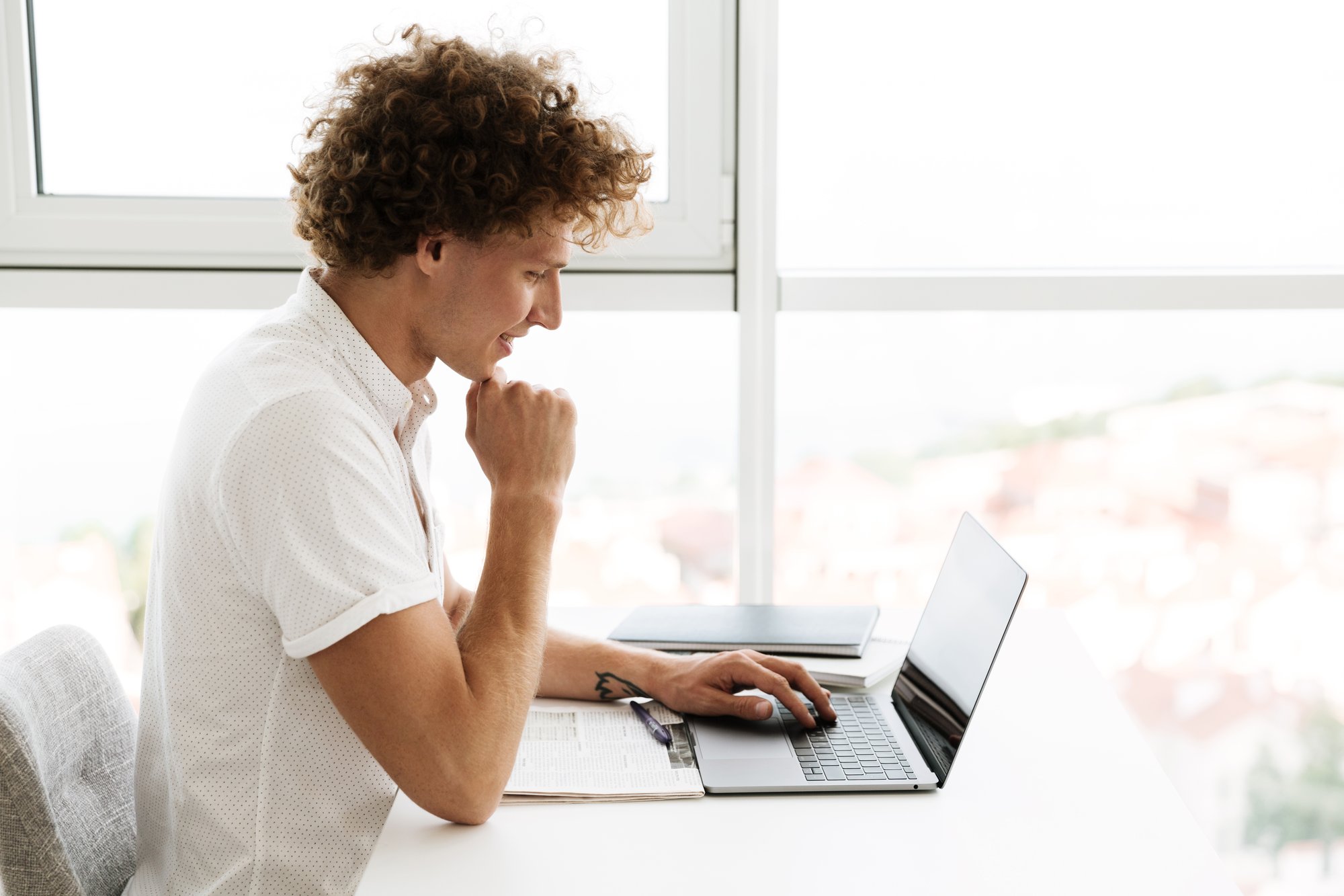 handsome-concentrated-serious-man-using-laptop-computer